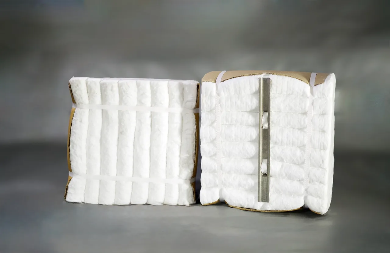 Two white ceramic fiber modules with metal anchoring hardware